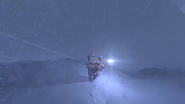 18:A climber struggles through a whiteout blizzard at night.