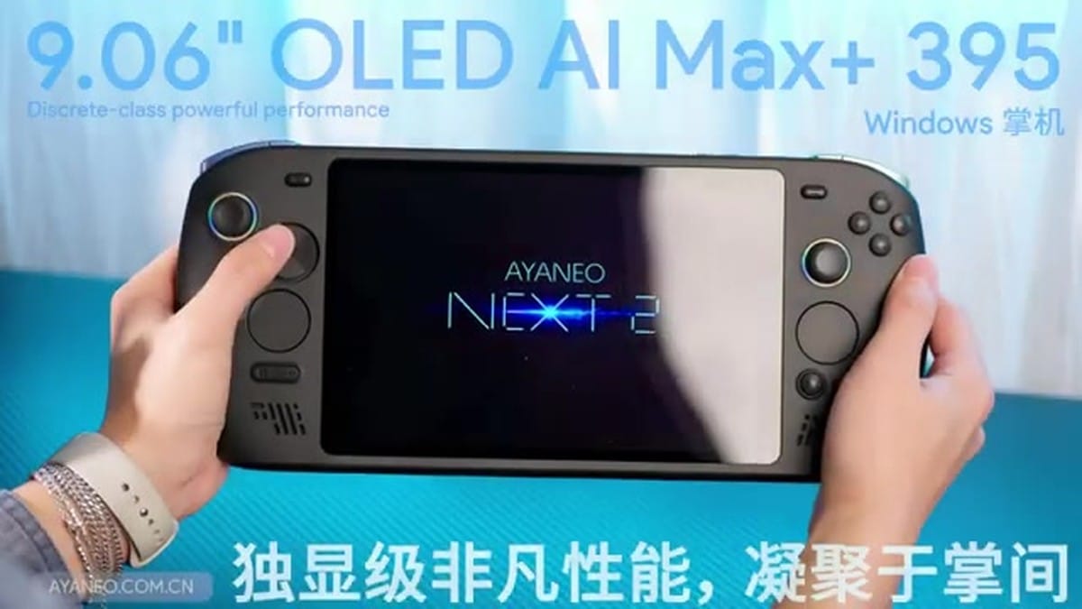 Front view of the AYANEO NEXT 2 held in hands, showing the large 9.06-inch OLED screen.