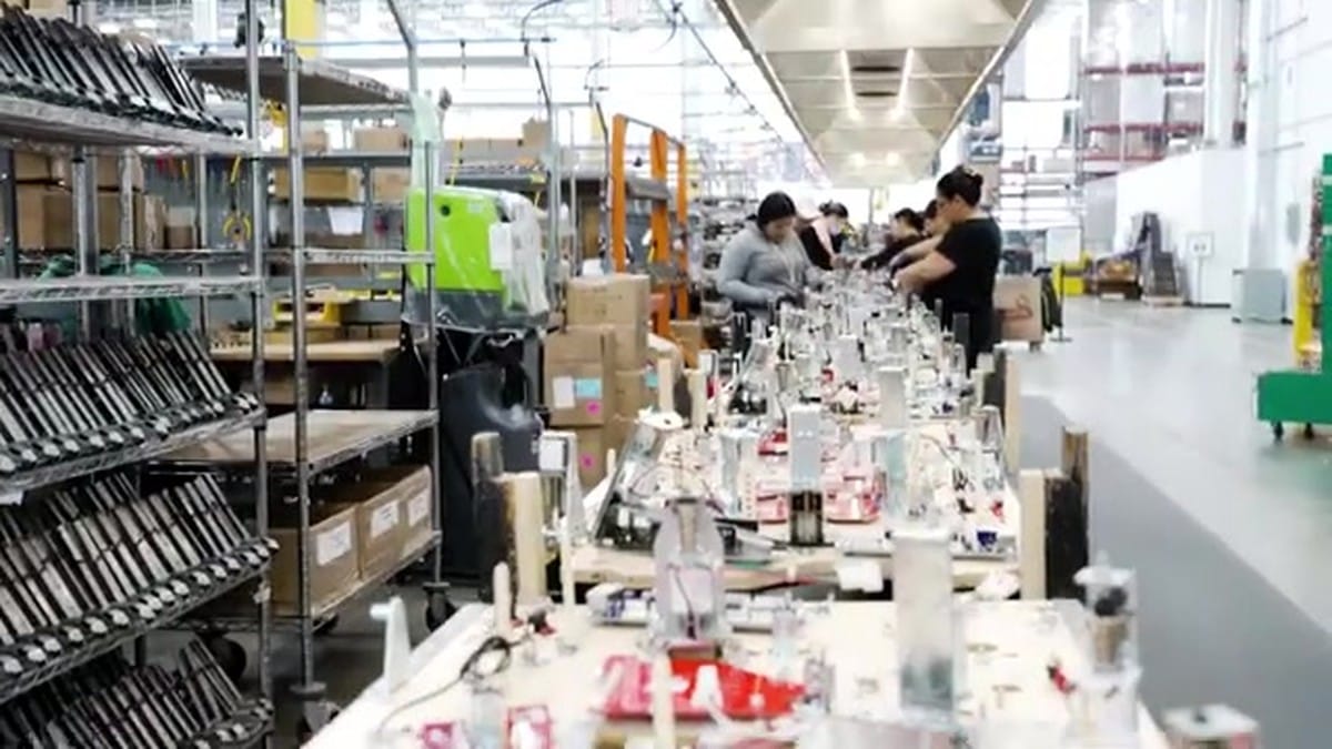 A wide shot of the modern Stern Pinball factory assembly line with dozens of machines in production.