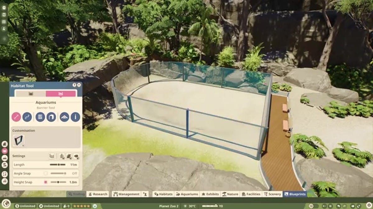 A family of guests looking through a massive glass viewing pane at Hawksbill turtles swimming in a detailed coral reef aquarium.