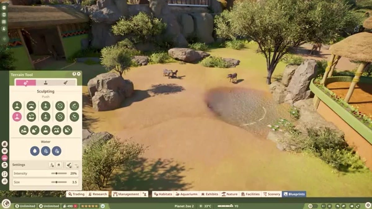 A Masai giraffe drinking from a pond with a management UI overlay showing Terrain, Plants, and Drinking Water status bars.