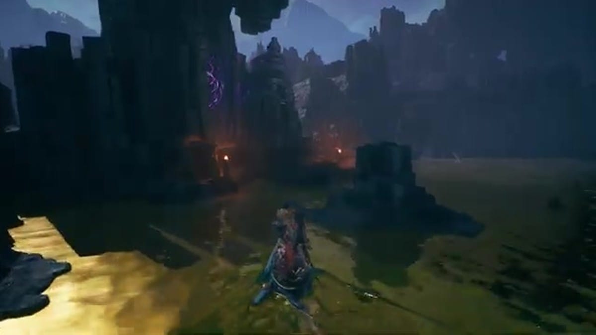 Raji climbing a giant ancient stone face carved into a cliffside