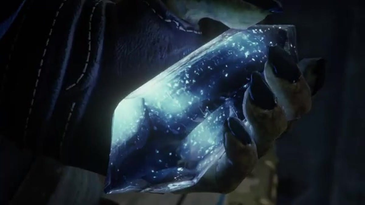 A close-up of Styx holding a large, glowing blue quartz crystal.