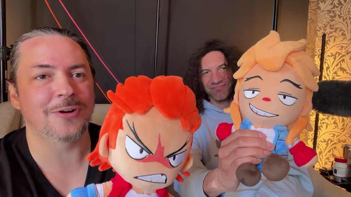 Dan Avidan holding up the Jimmy Lee plushie, which has a smug, smiling expression.