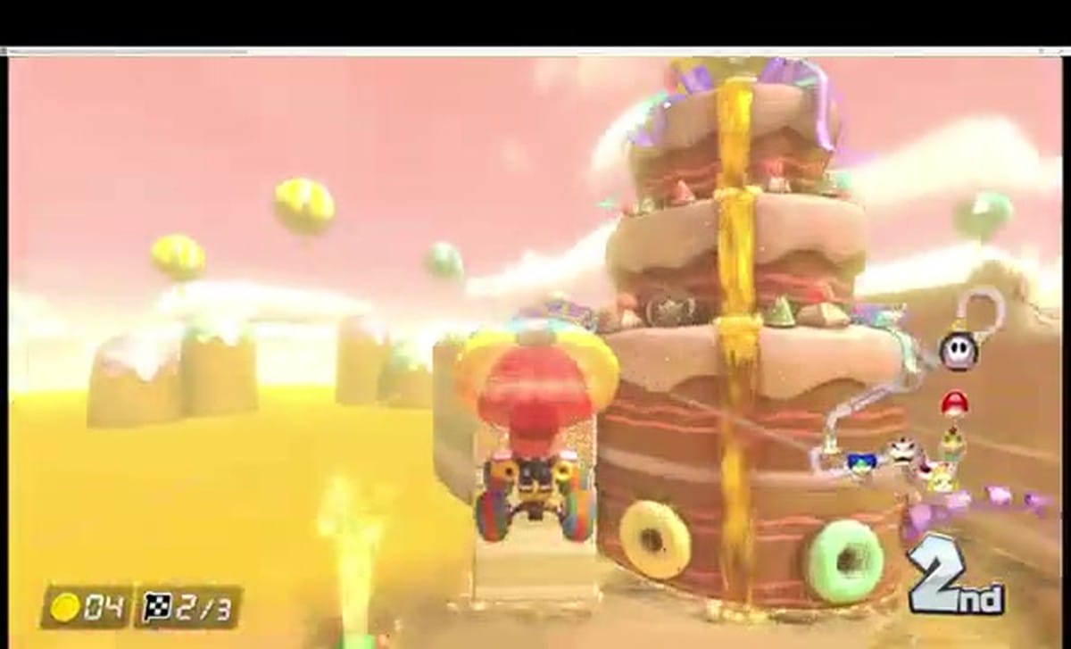 Pink Shy Guy gliding past the giant cake centerpiece on Sweet Sweet Canyon