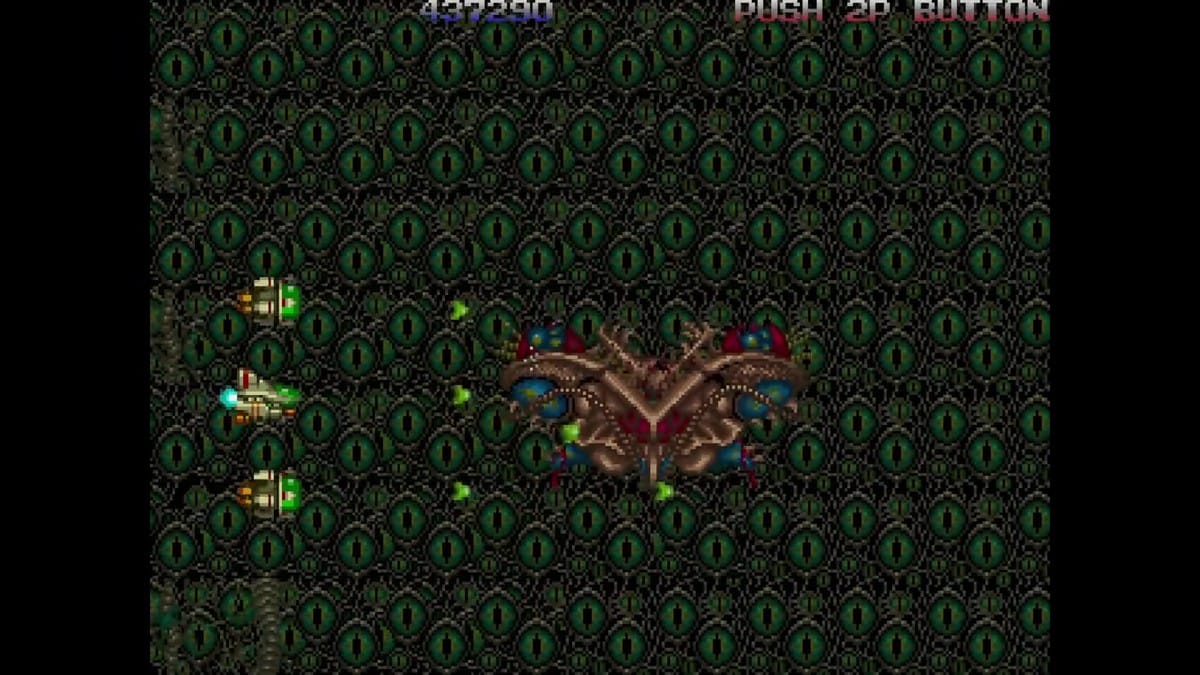 The Stage 1 boss battle against the ornate mechanical moth/butterfly-like craft against an eye-patterned backdrop.