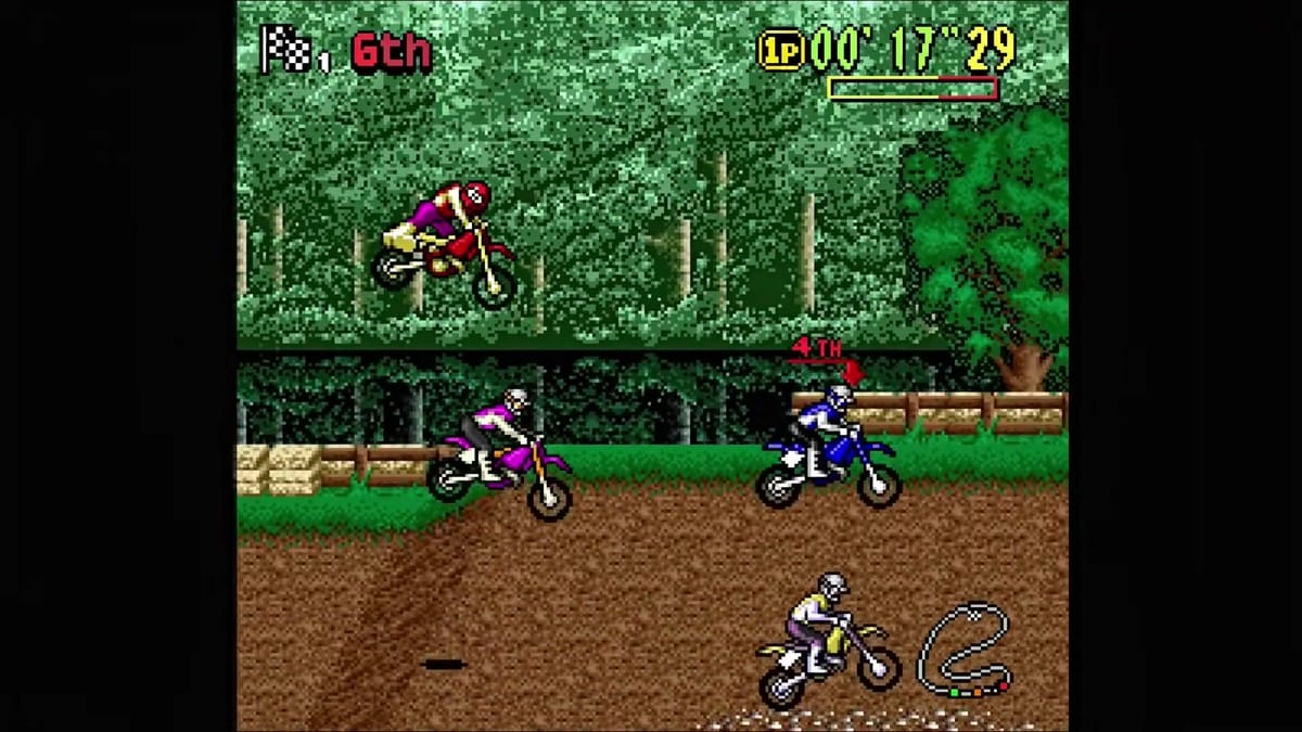 Racer tumbling off his bike over wooden logs and laying stunned on the track
