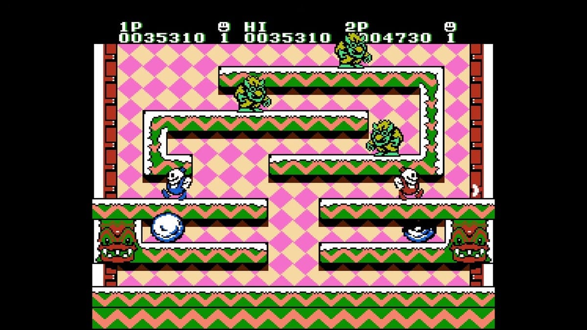 Two-player co-op gameplay showing Nick and Tom turning enemies into snowballs.
