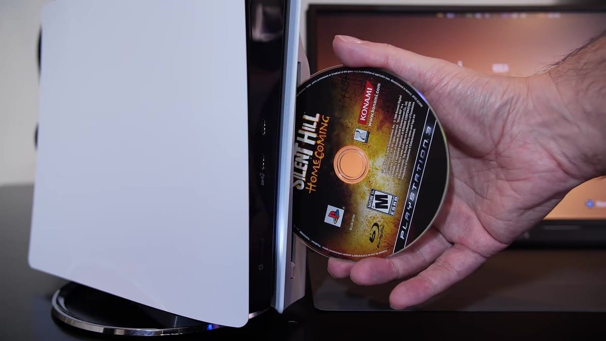Inserting a physical game disc into the PS5 optical drive slot