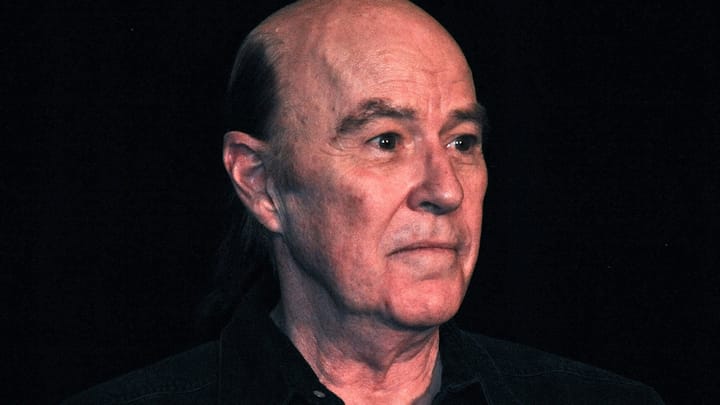 Reggie Bannister smiling in a promotional photo